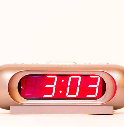 Electronic clock alarm clock with red illumination and the time 3:03