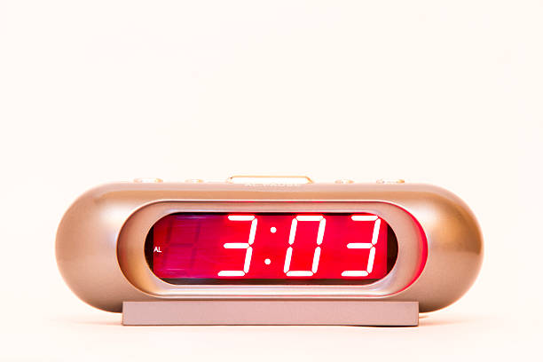Electronic clock alarm clock with red illumination and the time 3:03